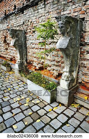 "Stone sculptures and bamboo in front of a brick wall, Amalienpassage, Munich, Bavaria, Germany, Europe" View Large Photo Image Stock Photo - "Stone sculptures and bamboo in front of a brick wall, Amalienpassage, Munich, Bavaria, Germany, Europe". Fotosearch