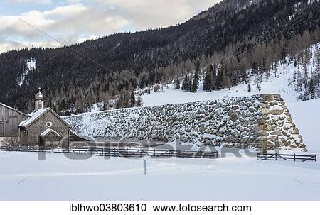 "Stone wall as protection against avalanches, behind wooden church, rear Paznauntal, Galtur, Tirol, Austria, Europe" View Large Photo Image Stock Image - "Stone wall as protection against avalanches, behind wooden church, rear Paznauntal, Galtur, Tirol, Austria, Europe". Fotosearch