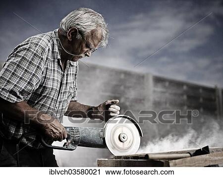 "Stonemason cutting a stone slab with an angle grinder with a cutting disc, Reith im Alpbachtal, Kufstein District, North Tirol, Tirol, Austria, Europe" View Large Photo Image Stock Image - "Stonemason cutting a stone slab with an angle grinder with a cutting disc, Reith im Alpbachtal, Kufstein District, North Tirol, Tirol, Austria, Europe". Fotosearch