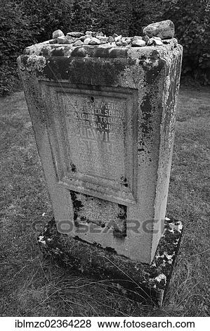 Stock Photo - "Stones lying on a headstone as a sign of remembrance, headstone with the names of the murdered Jews of Schnaittach during the Nazi era, third Jewish cemetery of 1897, Schnaittach, Middle Franconia, Bavaria, Germany, Europe". Fotosearch