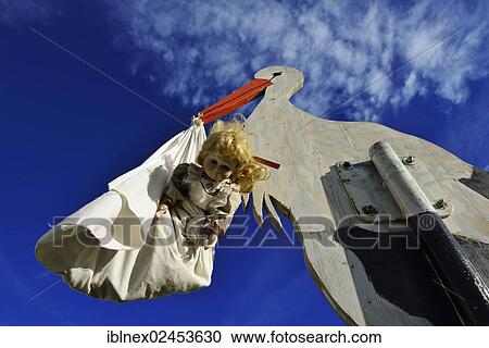 "Stork bringing a baby, wooden figure, Tannberg Mountain, Koestendorf, Lake Waller, Salzburg Lakes District, Salzburg, Austria, Europe" View Large Photo Image Stock Image - "Stork bringing a baby, wooden figure, Tannberg Mountain, Koestendorf, Lake Waller, Salzburg Lakes District, Salzburg, Austria, Europe". Fotosearch