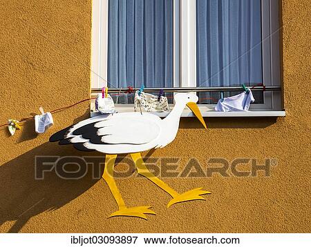 "Stork figure and baby clothing attached to a house, custom for newborn babies, Bonn, Rhineland, North Rhine-Westphalia, Germany, Europe" View Large Photo Image Stock Photo - "Stork figure and baby clothing attached to a house, custom for newborn babies, Bonn, Rhineland, North Rhine-Westphalia, Germany, Europe". Fotosearch