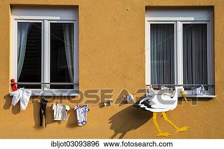 "Stork figure and baby clothing attached to a house, custom for newborn babies, Bonn, Rhineland, North Rhine-Westphalia, Germany, Europe" View Large Photo Image Stock Photograph - "Stork figure and baby clothing attached to a house, custom for newborn babies, Bonn, Rhineland, North Rhine-Westphalia, Germany, Europe". Fotosearch