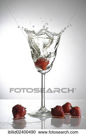 Strawberry being dropped into a champagne glass View Large Photo Image Stock Image - Strawberry being dropped into a champagne glass. Fotosearch