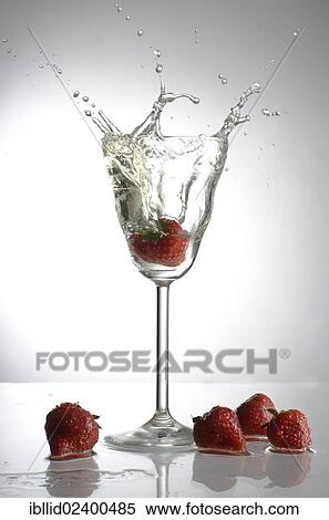 Strawberry being dropped into a champagne glass View Large Photo Image Stock Photography - Strawberry being dropped into a champagne glass. Fotosearch