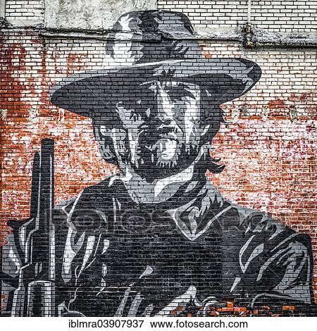 Stock Photo - "Street art, mural of a cowboy on a brick wall, Clarksdale, Mississippi, United States, North America". Fotosearch