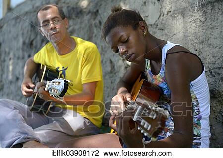 "Street child, girl, 15, having guitar lessons with a social worker and musician, Sao Martinho social project, Lapa district, Rio de Janeiro, Rio de Janeiro State, Brazil, South America" View Large Photo Image Stock Image - "Street child, girl, 15, having guitar lessons with a social worker and musician, Sao Martinho social project, Lapa district, Rio de Janeiro, Rio de Janeiro State, Brazil, South America". Fotosearch