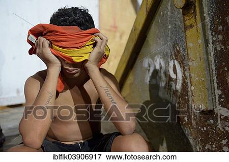 "Street child, teenager, 13 years, covering his face, Fortaleza, Ceara, Brazil, South America" View Large Photo Image Stock Photo - "Street child, teenager, 13 years, covering his face, Fortaleza, Ceara, Brazil, South America". Fotosearch