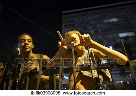 "Street children, child and adolescent, at night, on the fence of a park in the centre of Rio de Janeiro, Rio de Janeiro State, Brazil, South America" View Large Photo Image Stock Photo - "Street children, child and adolescent, at night, on the fence of a park in the centre of Rio de Janeiro, Rio de Janeiro State, Brazil, South America". Fotosearch