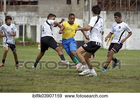 Stock Photo - "Street children playing a friendly soccer match against a youth team, preparation for the Street Children World Cup 2014, Fortaleza, Ceara, Brazil, South America". Fotosearch