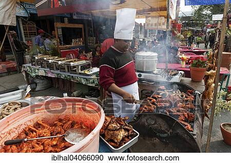"Street kitchen at the Pokhara Street Festival, Nepalese woman barbecuing meat, Pokhara, Nepal, Asia" View Large Photo Image Stock Image - "Street kitchen at the Pokhara Street Festival, Nepalese woman barbecuing meat, Pokhara, Nepal, Asia". Fotosearch