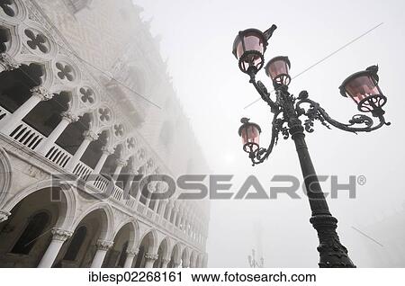 Stock Image - "Street lantern, Doge's Palace, Palazzo Ducale in the fog, Piazzetta San Marco, St. Mark's Square, Venice, Venezia, Veneto, Italy, Europe". Fotosearch