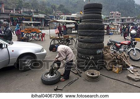 "Street scene, market stalls, car tyres, tyre repair workshop, Mugling, Nepal, Asia" View Large Photo Image Stock Photograph - "Street scene, market stalls, car tyres, tyre repair workshop, Mugling, Nepal, Asia". Fotosearch