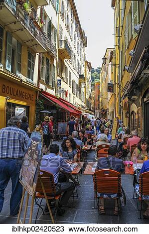 Street scene with a street cafe and passers-by, Nice, Cote d'Azur, France, Europe View Large Photo Image Stock Image - Street scene with a street cafe and passers-by, Nice, Cote d'Azur, France, Europe. Fotosearch