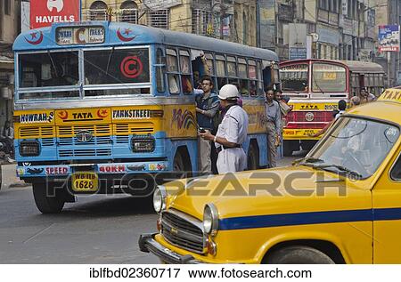 "Street scene with public bus, taxi and policeman, Kolkata, India, Asia" View Large Photo Image Stock Photo - "Street scene with public bus, taxi and policeman, Kolkata, India, Asia". Fotosearch