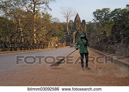 "Street sweeper in front of the southern gate of Angkor Thom, Angkor Thom, Siem Reap, Siem Reap Province, Cambodia, Asia" View Large Photo Image Stock Photograph - "Street sweeper in front of the southern gate of Angkor Thom, Angkor Thom, Siem Reap, Siem Reap Province, Cambodia, Asia". Fotosearch