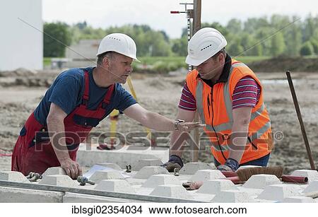 "Structural engineers placing the first blocks during a building site load test, at a construction site in Fridolfing, Bavaria, Germany, Europe" View Large Photo Image Picture - "Structural engineers placing the first blocks during a building site load test, at a construction site in Fridolfing, Bavaria, Germany, Europe". Fotosearch