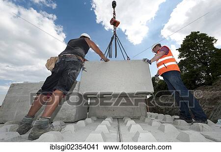 "Structural engineers placing the first blocks during a building site load test, at a construction site in Fridolfing, Bavaria, Germany, Europe" View Large Photo Image Stock Image - "Structural engineers placing the first blocks during a building site load test, at a construction site in Fridolfing, Bavaria, Germany, Europe". Fotosearch