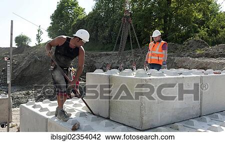 "Structural engineers placing the first blocks during a building site load test, at a construction site in Fridolfing, Bavaria, Germany, Europe" View Large Photo Image Stock Image - "Structural engineers placing the first blocks during a building site load test, at a construction site in Fridolfing, Bavaria, Germany, Europe". Fotosearch