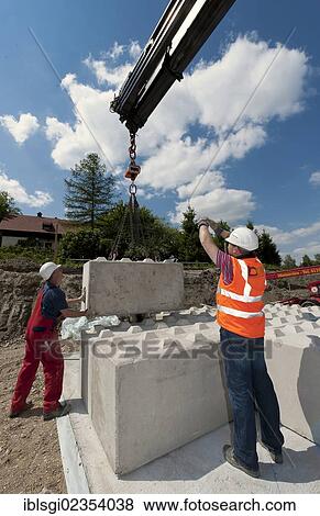 "Structural engineers placing the first blocks during a building site load test, at a construction site in Fridolfing, Bavaria, Germany, Europe" View Large Photo Image Stock Photo - "Structural engineers placing the first blocks during a building site load test, at a construction site in Fridolfing, Bavaria, Germany, Europe". Fotosearch