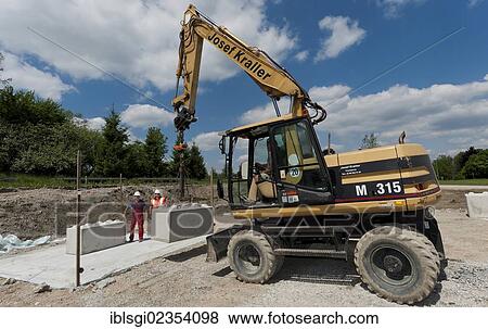 Stock Photo - "Structural engineers placing the first blocks during a building site load test, at a construction site in Fridolfing, Bavaria, Germany, Europe". Fotosearch