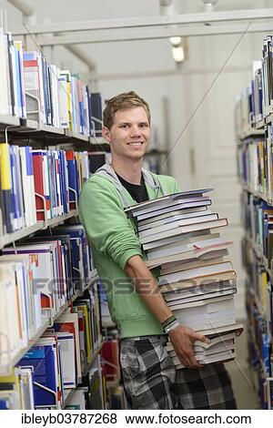 "Student carrying a stack of books in the Departmental Library of the University of Hohenheim, Stuttgart, Baden-Wurttemberg, Germany, Europe" View Large Photo Image Stock Photo - "Student carrying a stack of books in the Departmental Library of the University of Hohenheim, Stuttgart, Baden-Wurttemberg, Germany, Europe". Fotosearch