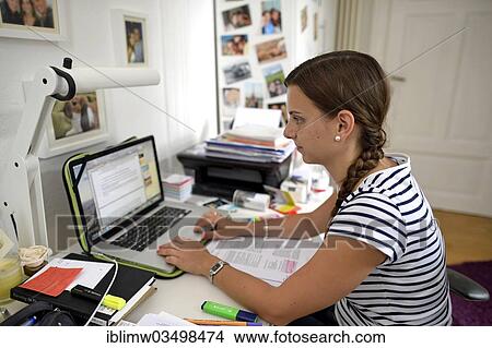 Picture - "Student in a college dorm writing on a laptop, Heidelberg, Baden-Wurttemberg, Germany, Europe". Fotosearch