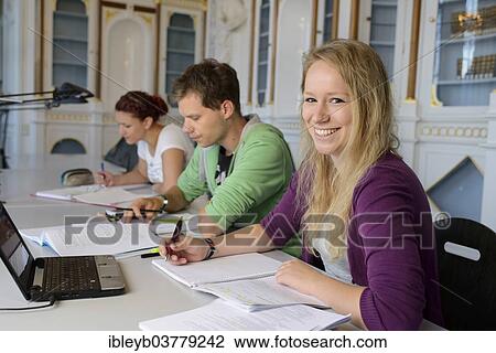 Stock Image - "Students studying in the departmental library of the University of Hohenheim in Schloss Hohenheim Palace, Stuttgart, Baden-Wurttemberg, Germany, Europe". Fotosearch