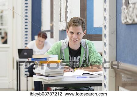 Stock Image - "Students studying in the departmental library of the University of Hohenheim in Schloss Hohenheim Palace, Stuttgart, Baden-Wurttemberg, Germany, Europe". Fotosearch