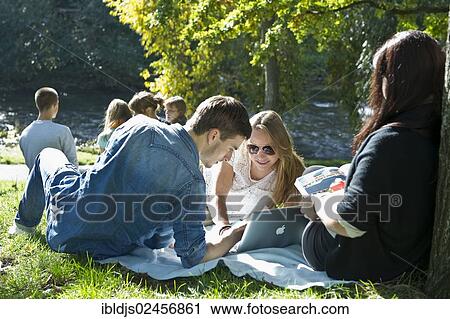 "Students with a laptop and books on a meadow, Freiburg im Breisgau, Baden-Wuerttemberg, Germany, Europe" View Large Photo Image Stock Image - "Students with a laptop and books on a meadow, Freiburg im Breisgau, Baden-Wuerttemberg, Germany, Europe". Fotosearch