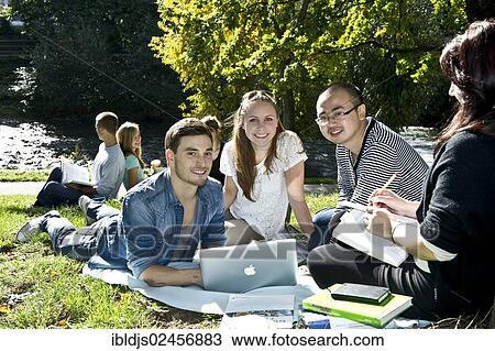 "Students with a laptop and books on a meadow, Freiburg im Breisgau, Baden-Wuerttemberg, Germany, Europe" View Large Photo Image Stock Image - "Students with a laptop and books on a meadow, Freiburg im Breisgau, Baden-Wuerttemberg, Germany, Europe". Fotosearch