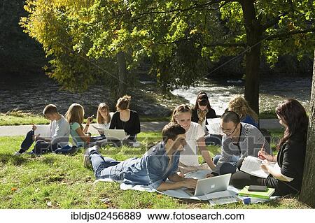 "Students with laptops and books on a meadow, Freiburg im Breisgau, Baden-Wuerttemberg, Germany, Europe" View Large Photo Image Stock Photo - "Students with laptops and books on a meadow, Freiburg im Breisgau, Baden-Wuerttemberg, Germany, Europe". Fotosearch