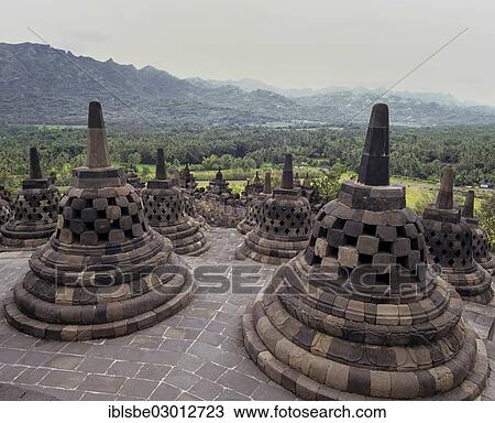 Stock Image - "Stupas on the terrace of the temple complex of Borobudur, view over the Kedu valley, UNESCO World Cultural Heritage Site, Yogyakarta, Borobudur, Yogyakarta, Java, Indonesia, Asia". Fotosearch