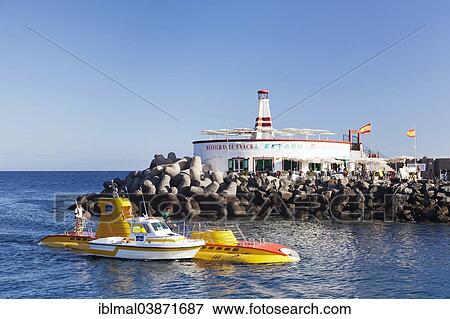 "Submarine Yellow Submarine in front of lighthouse, Puerto de Mogan, Gran Canaria, Canary Islands, Spain, Europe" View Large Photo Image Stock Photo - "Submarine Yellow Submarine in front of lighthouse, Puerto de Mogan, Gran Canaria, Canary Islands, Spain, Europe". Fotosearch