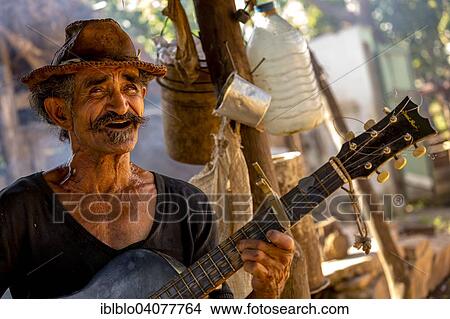 "Sugar cane farmer playing the guitar, Valle de los Ingenios, Trinidad, Sancti Spiritus Province, Cuba, North America" View Large Photo Image Picture - "Sugar cane farmer playing the guitar, Valle de los Ingenios, Trinidad, Sancti Spiritus Province, Cuba, North America". Fotosearch