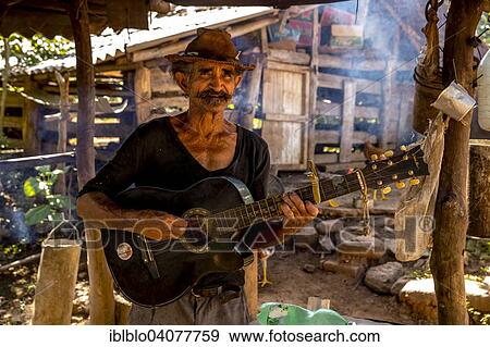 "Sugar cane farmer playing the guitar, Valle de los Ingenios, Trinidad, Sancti Spiritus Province, Cuba, North America" View Large Photo Image Stock Photo - "Sugar cane farmer playing the guitar, Valle de los Ingenios, Trinidad, Sancti Spiritus Province, Cuba, North America". Fotosearch