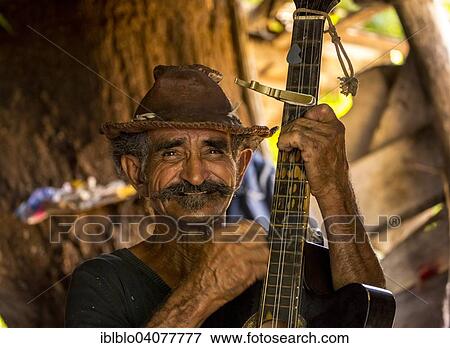 "Sugar cane farmer playing the guitar, Valle de los Ingenios, Trinidad, Sancti Spiritus Province, Cuba, North America" View Large Photo Image Stock Photo - "Sugar cane farmer playing the guitar, Valle de los Ingenios, Trinidad, Sancti Spiritus Province, Cuba, North America". Fotosearch