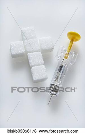 "Sugar cubes in a cross-shape with a syringe filled with insulin, insulin injection" View Large Photo Image Stock Photo - "Sugar cubes in a cross-shape with a syringe filled with insulin, insulin injection". Fotosearch