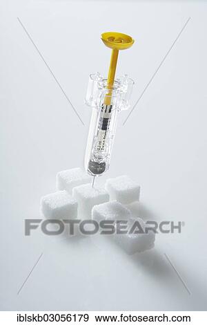 "Sugar cubes in a cross-shape with a syringe filled with insulin, insulin injection" View Large Photo Image Stock Photo - "Sugar cubes in a cross-shape with a syringe filled with insulin, insulin injection". Fotosearch