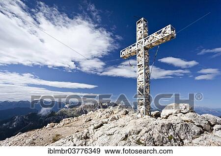 "Summit cross of Croda Rossa or Sextener Rotwand in the Rosengarten Group, looking towards Latemar Mountain, Dolomites, Alto Adige, Italy, Europe" View Large Photo Image Stock Photo - "Summit cross of Croda Rossa or Sextener Rotwand in the Rosengarten Group, looking towards Latemar Mountain, Dolomites, Alto Adige, Italy, Europe". Fotosearch