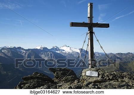 Stock Photo - "Summit cross of Rastkogel Moutain in front of the Tux Alps, Zillertaler Alpen, Tyrol, Austria, Europe". Fotosearch
