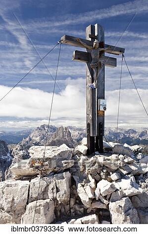 Stock Photography - "Summit cross of Sextener Rotwand Mountain in the Sexten Dolomites, in front of the Three Peaks, Alta Pusteria, Dolomites, Alto Adige, Italy, Europe". Fotosearch