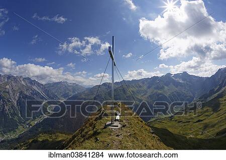 Picture - "Summit cross on Burtschakopf mountain, Eisentaler Gruppe mountains, Klostertal valley on the left, Kaltenberggruppe mountains at the right, Verwall mountains, Vorarlberg, Austria, Europe". Fotosearch