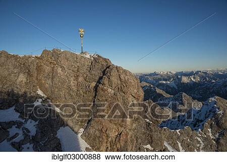 Stock Photo - "Summit cross on Mount Zugspitze, Garmisch-Partenkirchen, Grainau, Upper Bavaria, Bavaria, Germany, Europe, Zugspitze, Wetterstein mountain range, Eastern Alps, Grainau, Upper Bavaria, Bavaria, Germany, Europe". Fotosearch