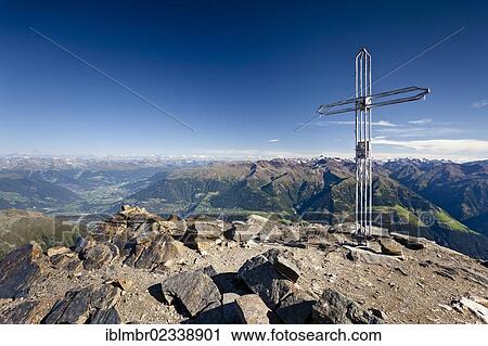 Stock Image - "Summit cross on Orgelspitz or Laaser Spitz Mountain above Laas, Vinschgau, with Upper Vinschgau at the rear, Alto Adige, Italy, Europe". Fotosearch
