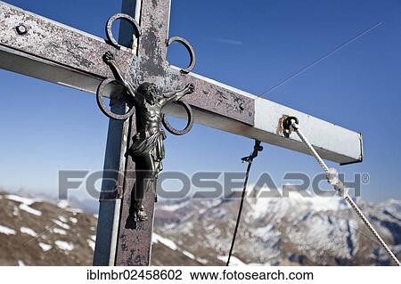 "Summit cross on the summit of Wilden Kreuzspitze Mountain in the Pfunderer Mountains, Hochfeiler Mountain at the rear, Alto Adige, Italy, Europe" View Large Photo Image Stock Image - "Summit cross on the summit of Wilden Kreuzspitze Mountain in the Pfunderer Mountains, Hochfeiler Mountain at the rear, Alto Adige, Italy, Europe". Fotosearch