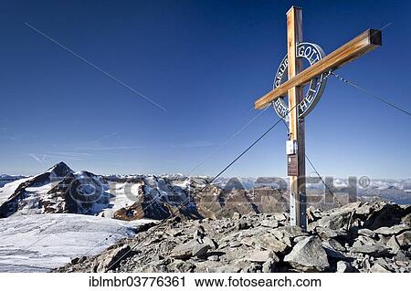 Stock Image - "Summit cross on Weissseespitze Mountain, looking towards Weisskugel Mountain, Langtaufers, Alta Val Venosta or Upper Vinschgau Valley, Alto Adige, Italy, Europe". Fotosearch