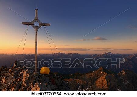 "Summit cross with a tent on Grosser Krottenkopf Mountain at sunrise, Allgauer Alpen, Tyrol, Austria, Europe" View Large Photo Image Picture - "Summit cross with a tent on Grosser Krottenkopf Mountain at sunrise, Allgauer Alpen, Tyrol, Austria, Europe". Fotosearch