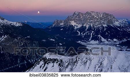 Stock Photography - "Summit of Mt Zugspitze with a full moon at dusk, Berwang, Ausserfern, Tyrol, Austria, Europe". Fotosearch