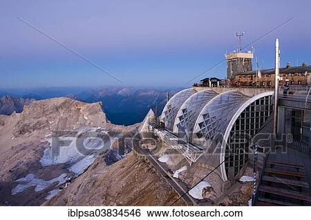 "Summit plateau of Mt Zugspitze with a terrace and Munchner Haus mountain hut, at dawn before sunrise, Bavaria, Germany, Europe" View Large Photo Image Stock Photograph - "Summit plateau of Mt Zugspitze with a terrace and Munchner Haus mountain hut, at dawn before sunrise, Bavaria, Germany, Europe". Fotosearch